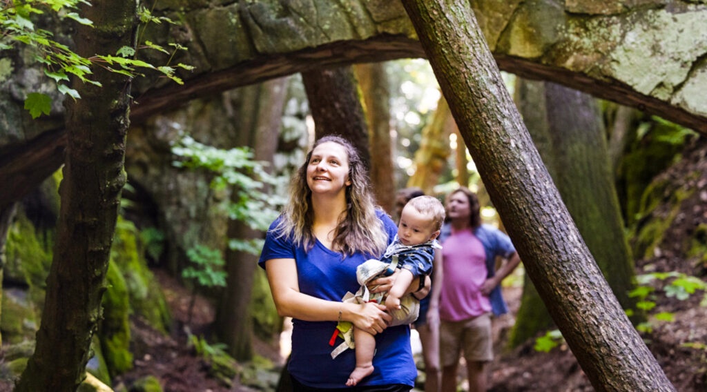 A family exploring the Enchanted Trail at Rock City, one of the best kid-friendly hiking trails with views on Lookout Mountain.
