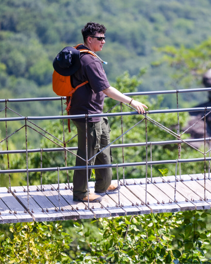 Crossing the Swing-A-Long Bridge, a top Chattanooga tourist attraction with incredible mountain views.