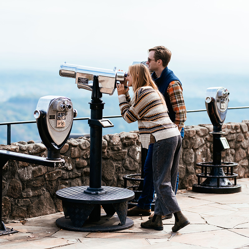 People looking through telescopes at Rock City.